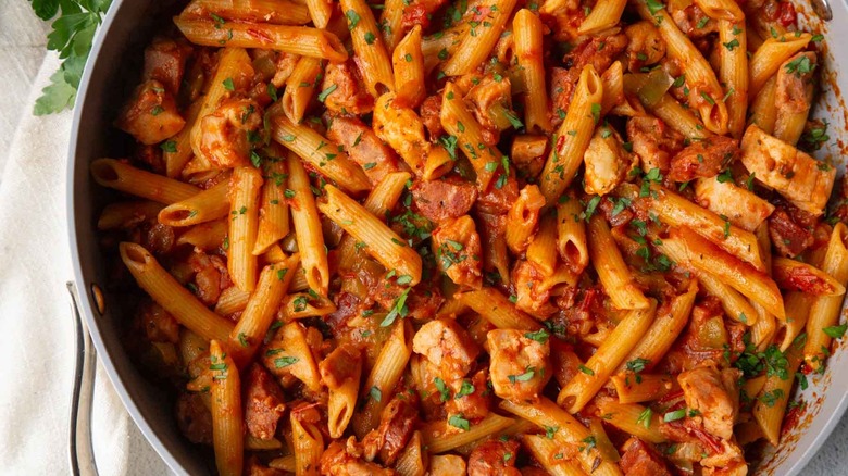 pasta with tomato sauce and parsley in a pan