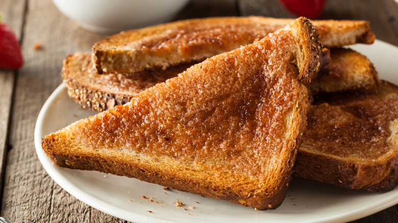 Slices of cinnamon toast on a white plate