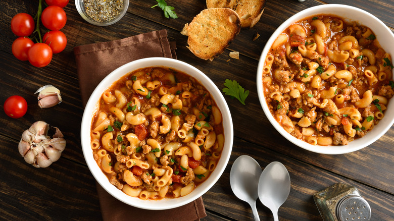Two bowls of American Goulash on a wooden table