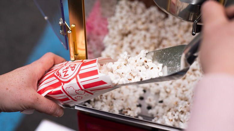Scooping carnival popcorn
