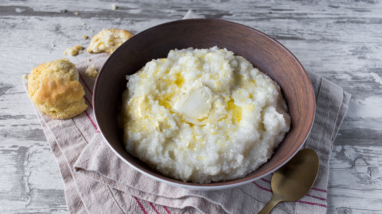 A bowl of grits with butter on top