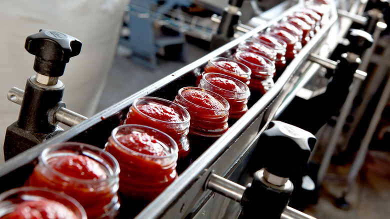 Ketchup jars on conveyor belt