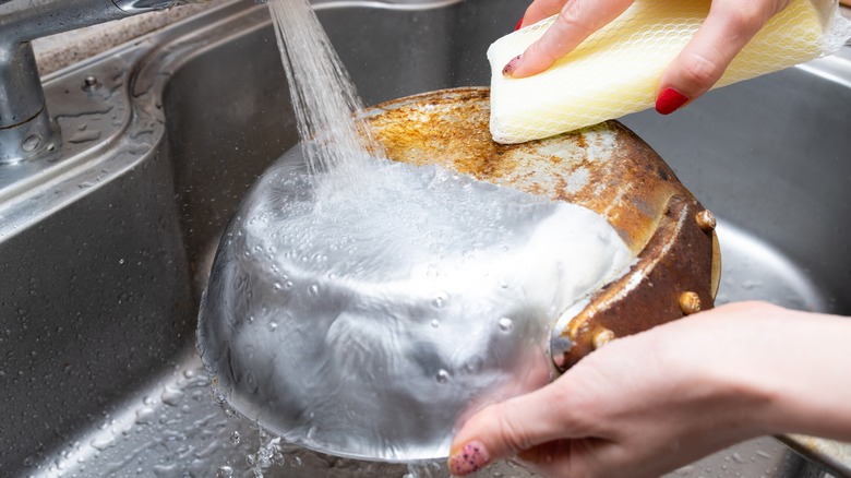 cleaning pot in sink