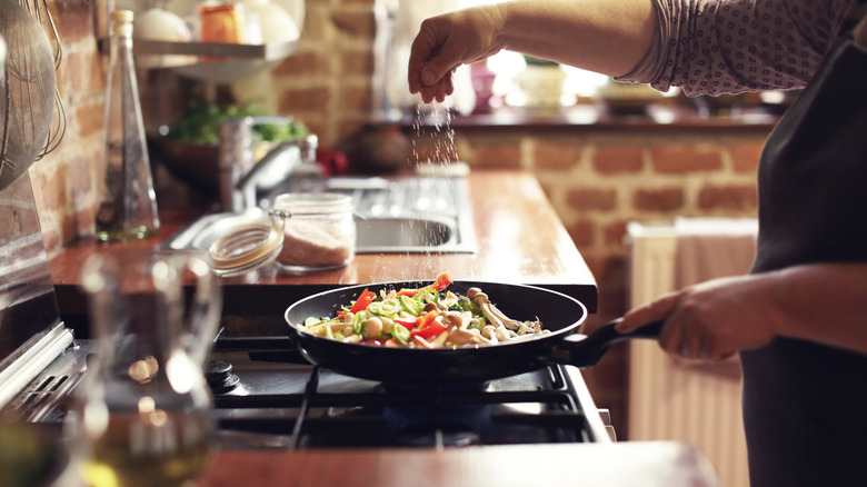 seasoning food on skillet