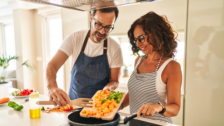 couple cooks in kitchen