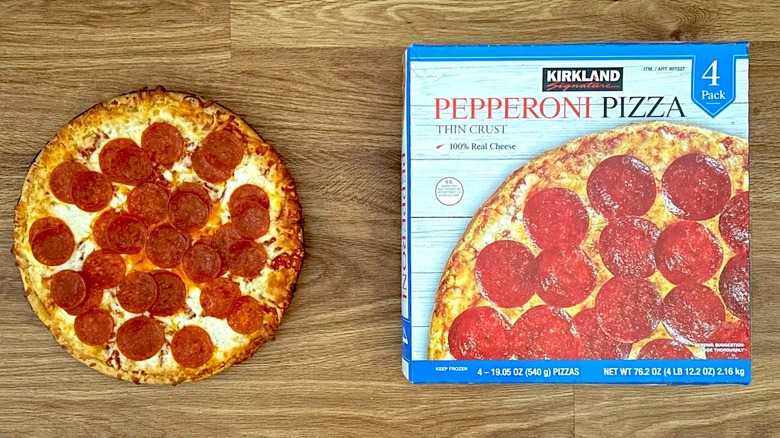 Package and baked Kirkland Signature Pepperoni Pizza on round plate