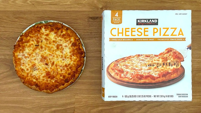 Package and baked Kirkland Signature Cheese Pizza on round plate