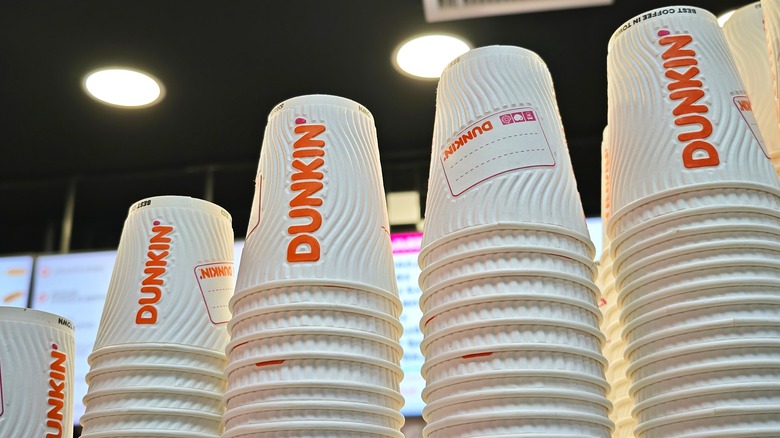 Several different sizes of Dunkin' coffee cups