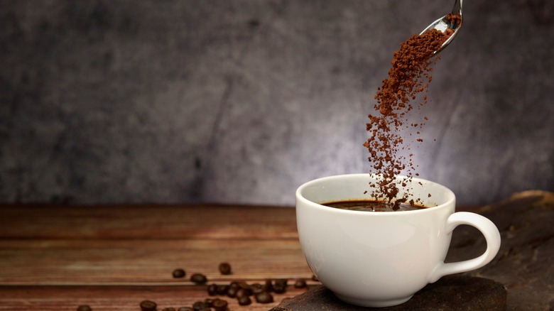 espresso powder being poured into cup