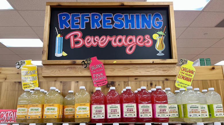 An aisle display at Trader Joe's with a board that reads Refreshing Beverages and a shelf full of various lemonades