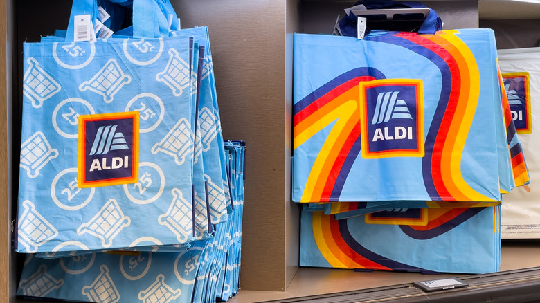 several different Aldi shopping bags hanging up