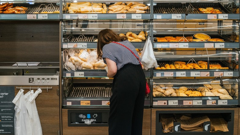 woman looking through bread section at Aldi