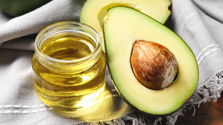 half an avocado and oil in jar
