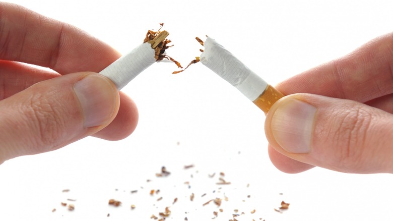 Breaking cigarette in half