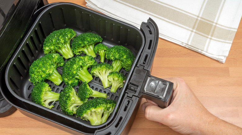 Broccoli in an air fryer basket