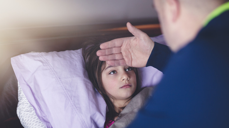 Young girl in bed with a fever
