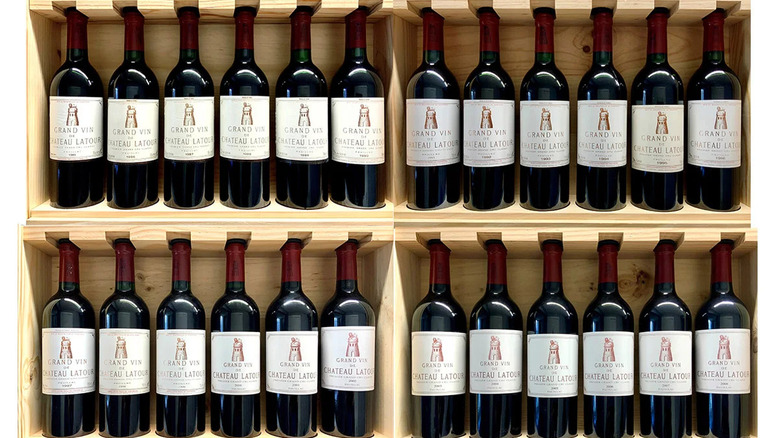 A glass of wine and a bottle of Pauillac wine.