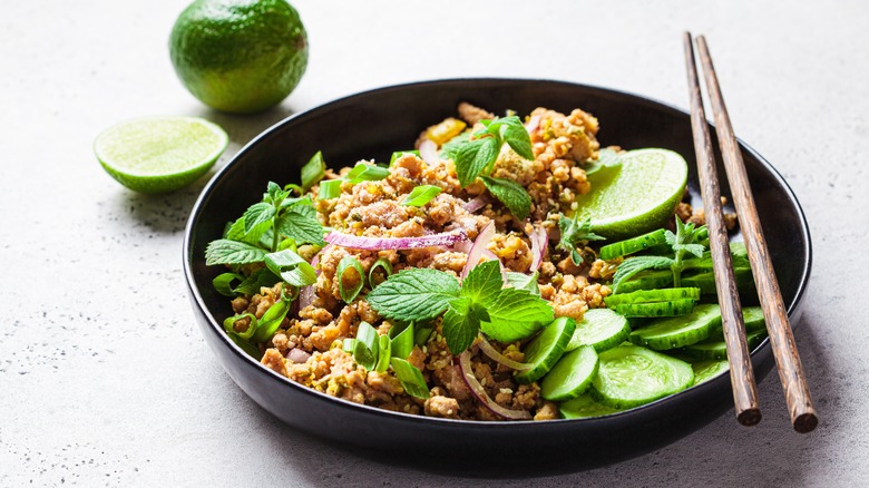 larb gai salad on black plate