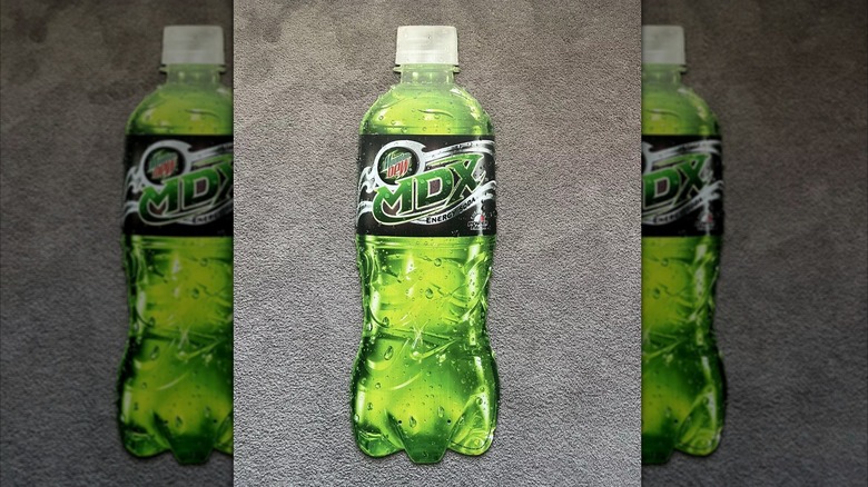 A bottle of Mountain Dew MDX on a grey background