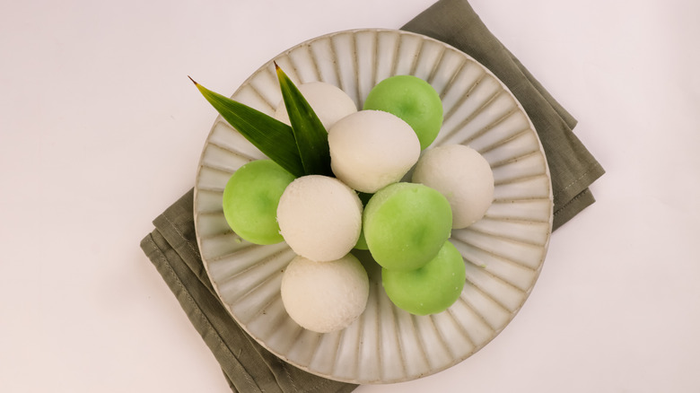 Plate of small, round, white and green puto