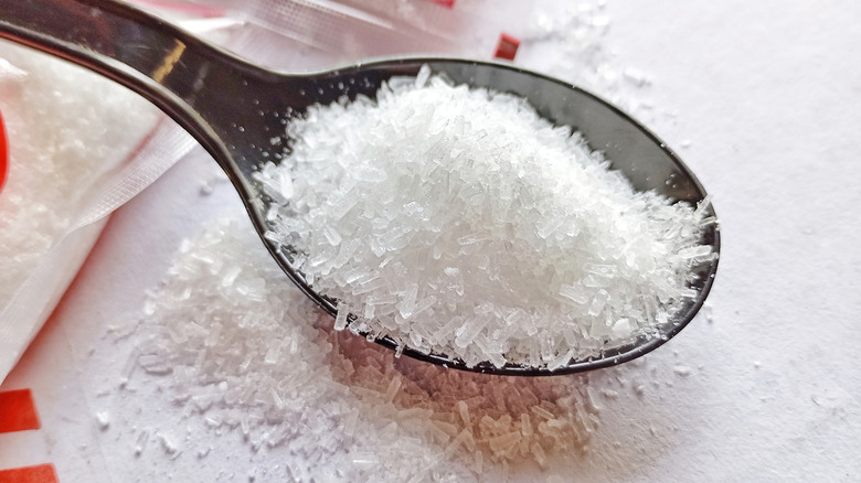 A spoonful of MSG on a white table