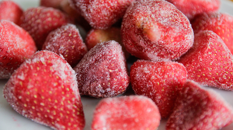 Frozen strawberries thawing on a plate