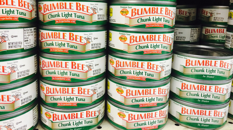 A grocery store aisle showing cans of Bumble Bee Chunk Light Tuna lined up