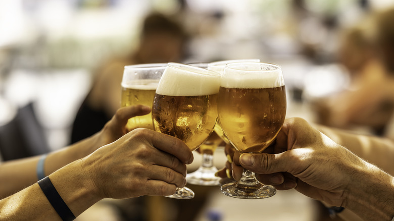 A group of friends toasting old school beer