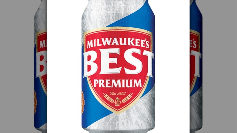 A person holding a can of Milwaukee's Best Premium