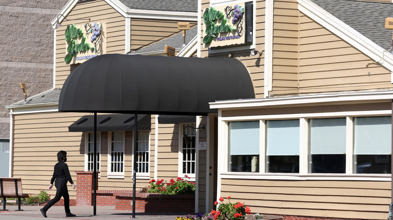 A worker walks into an Olive Garden restaurant