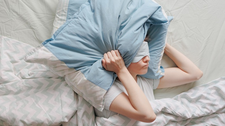 Woman with pillow around head