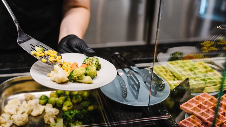 staff serving food at a buffet