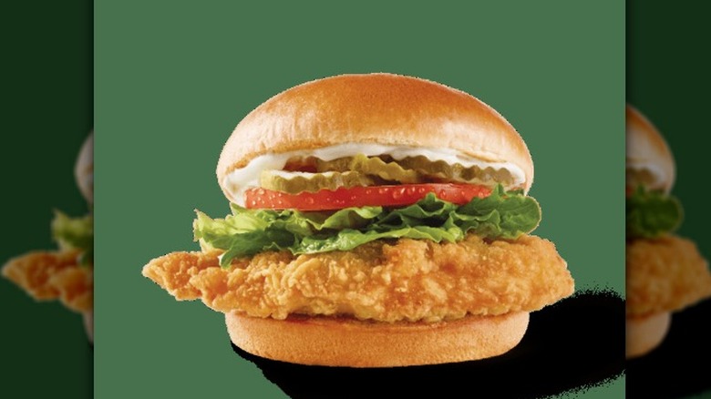 a Wendy's Classic Chicken Sandwich against a green background.