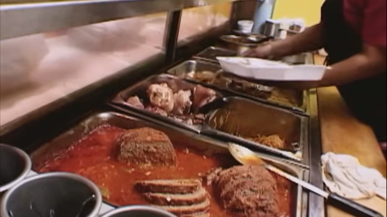 A cafeteria-style serving line at a soul food meat and three.
