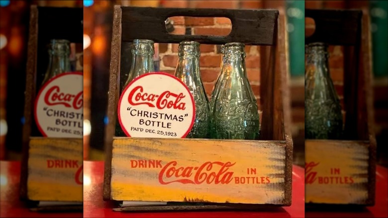 Coca-Cola 1923 Christmas bottles in a wooden 6-pack case.