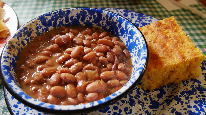 Beans and cornbread on a white and blue plate
