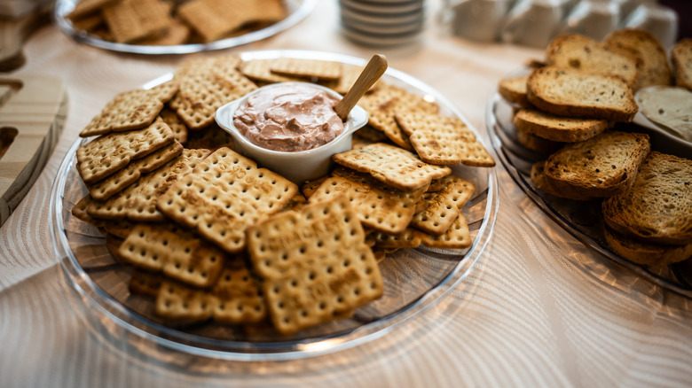 Canned roast beef spread served with a plate of seasoned crackers
