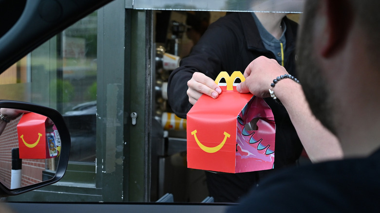 Happy Meal handed to customer through drive-thru window