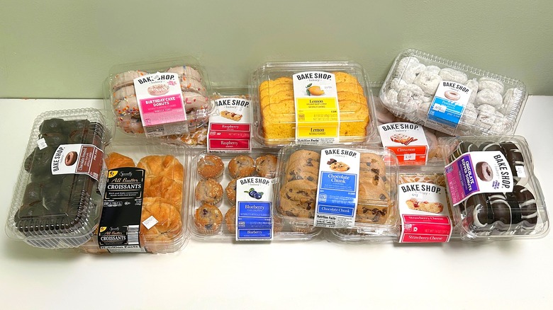 Several containers of Aldi Bake Shop products piled together on a green and white background