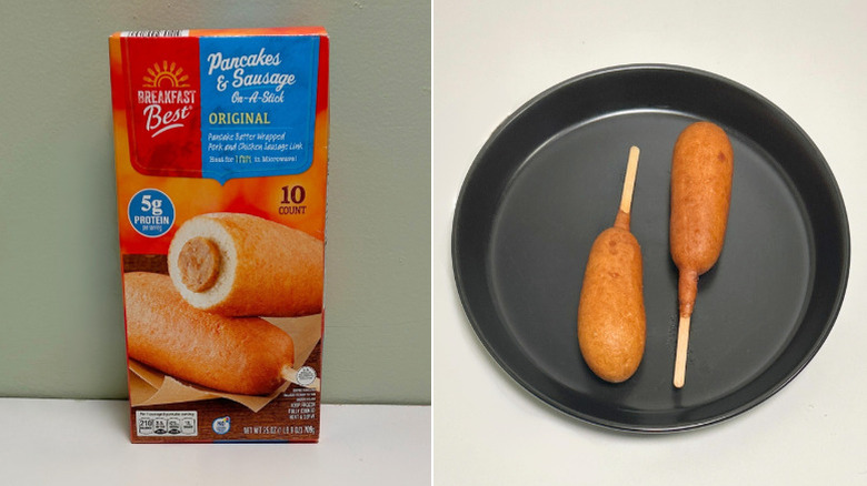 A box of Breakfast Best Pancakes on a stick next to a black plate with breakfast corndogs