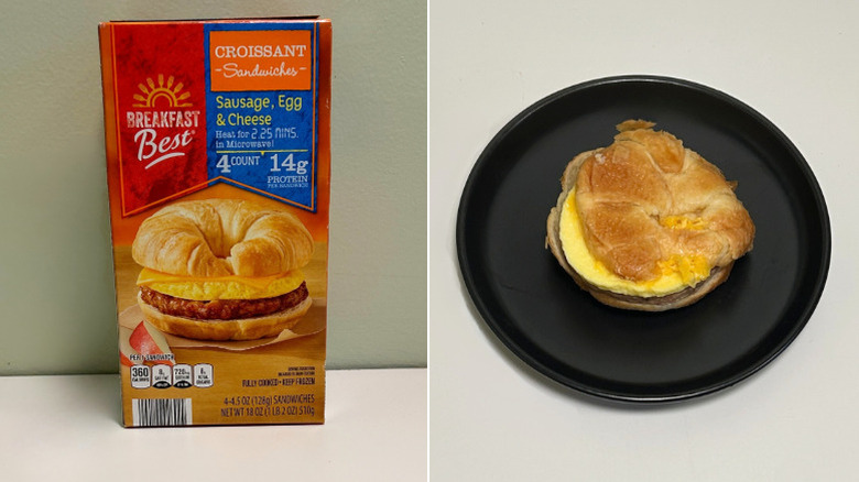 A box of Breakfast Best Croissants next to a black plate with a breakfast sandwich