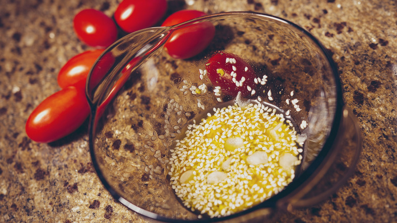 A marinade with oil, garlic, and sesame seeds