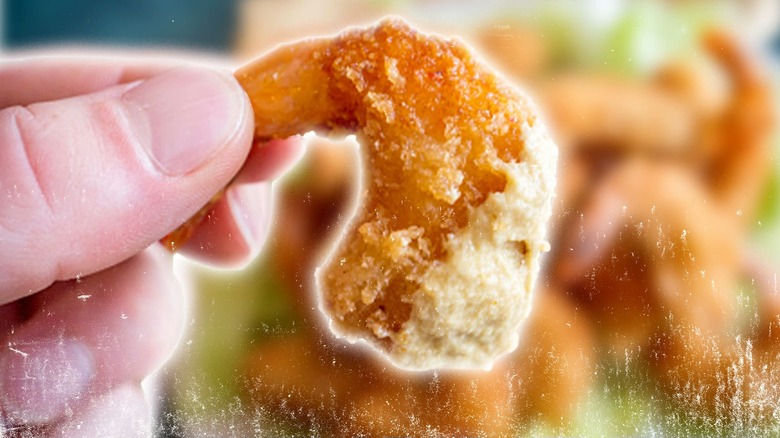 hand holding a popcorn shrimp