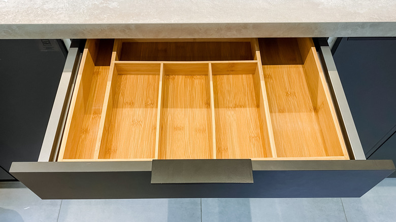 Open drawer displaying empty bamboo organizer
