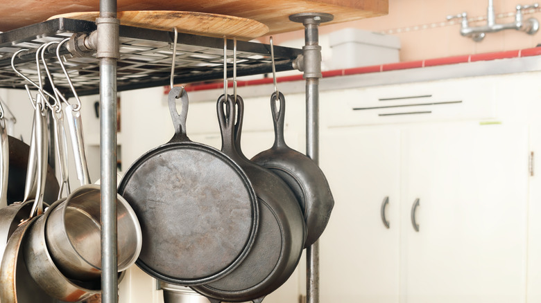 Pots and pans hanging under a kitchen island