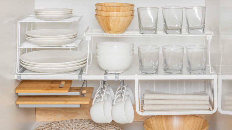 Cupboard shelves organized with detachable racks and shelving