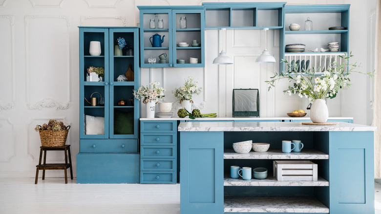 Perspective of kitchen island and blue cabinets