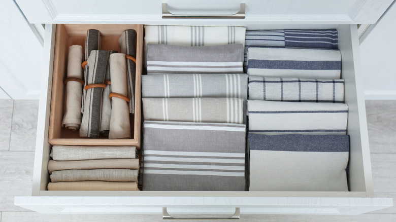 Open drawer displaying neatly folded kitchen towels