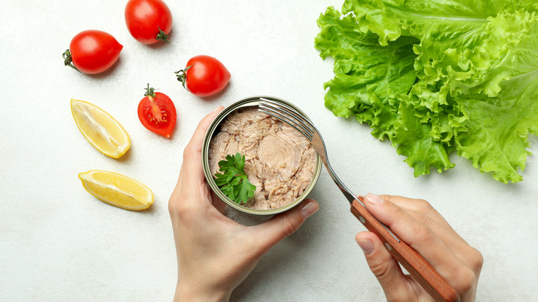Scooping tuna out of can