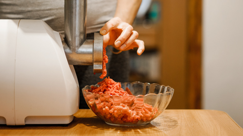woman grinding meat